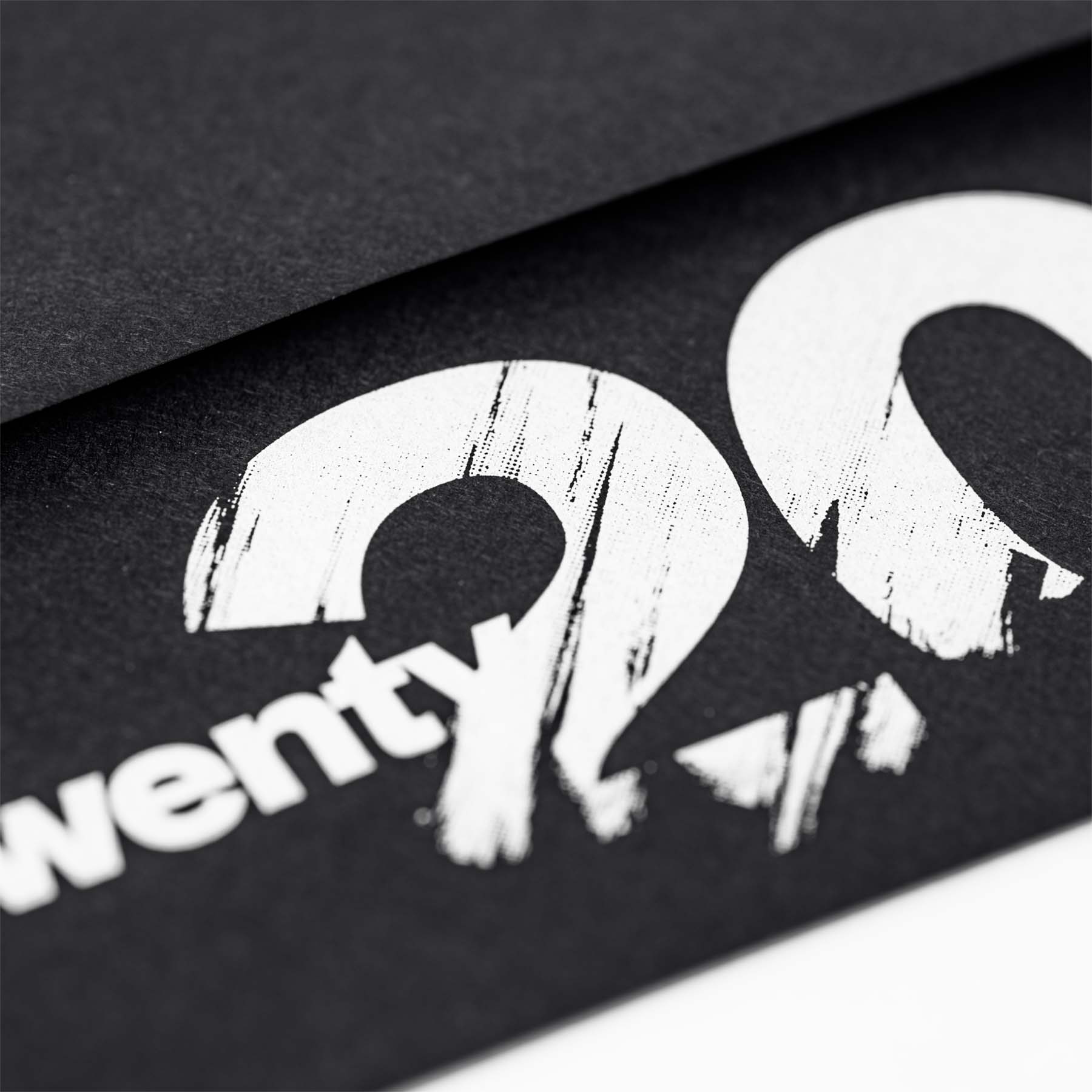 Black envelope with 2020 logo screen printed on the back side in white ink.